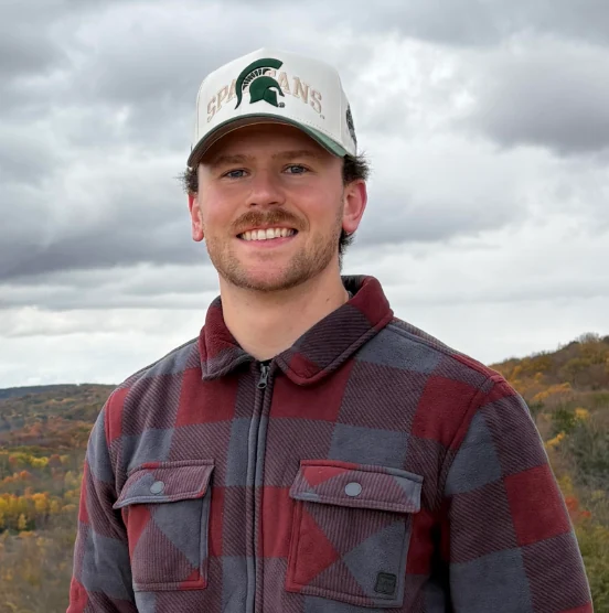 Nolan Houghteling in a Michigan State hat outdoors